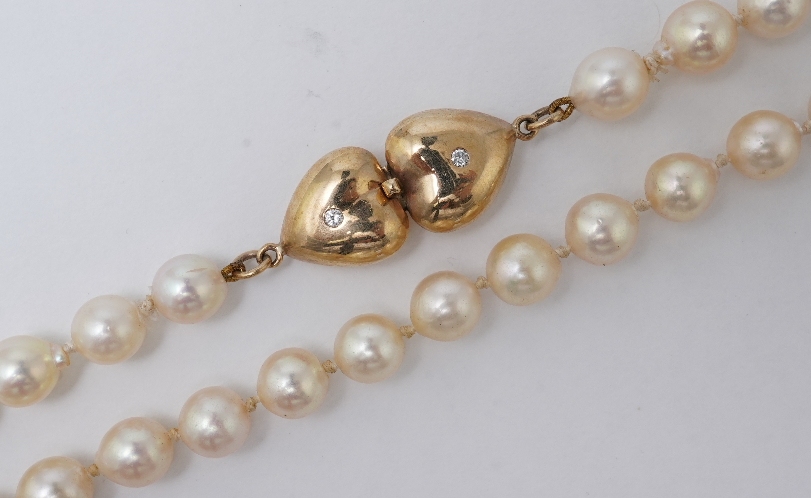 A cultured pearl, gold and diamond necklace